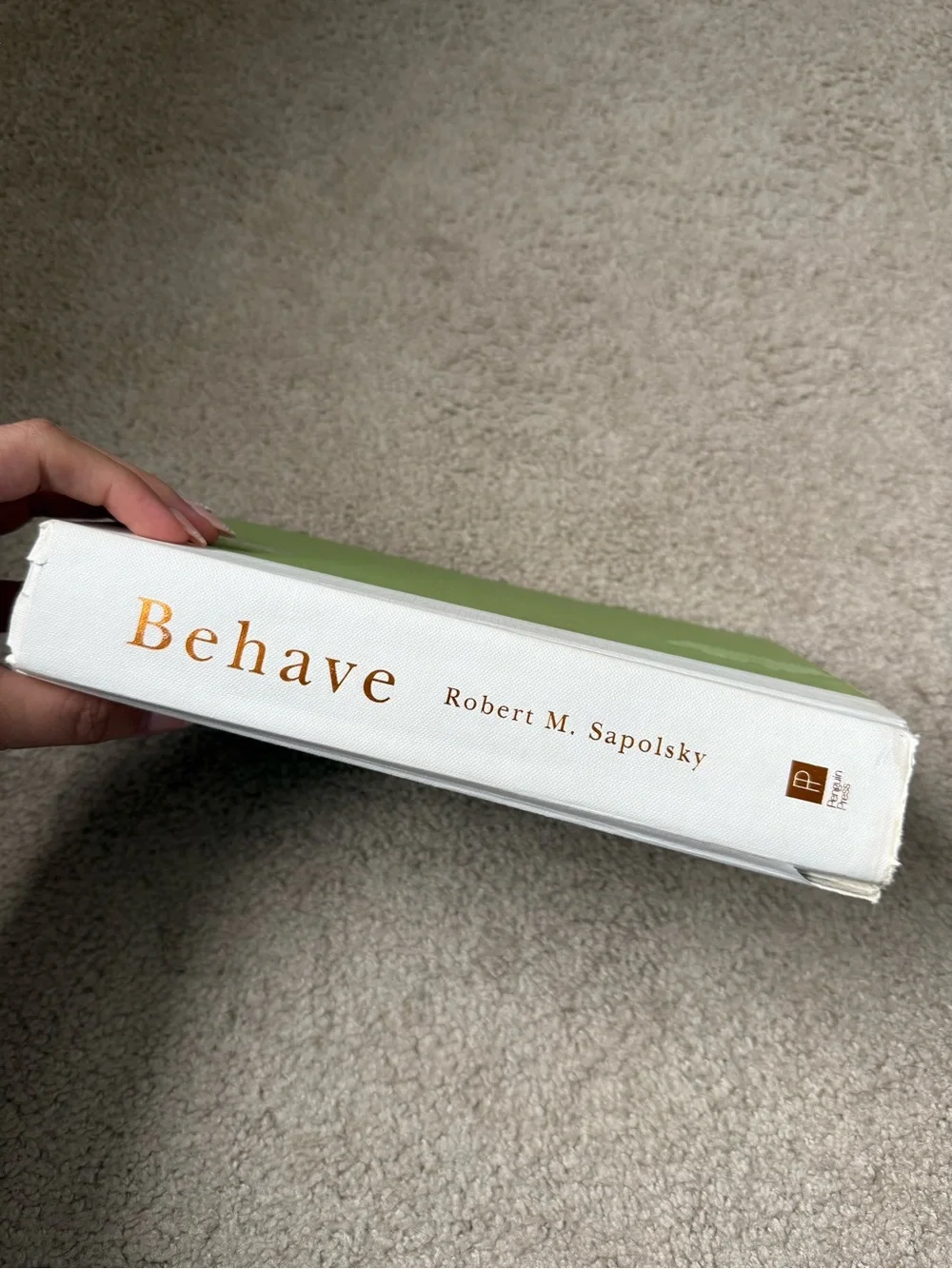 Behave by Robert M. Sapolsky - White & Green Hardcover
